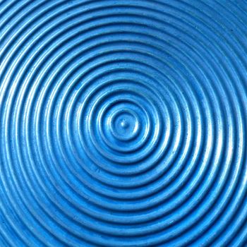 Abstract circle metal plate- blue surface with round lines.