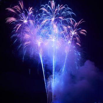 Blue colorful fireworks on the black sky background