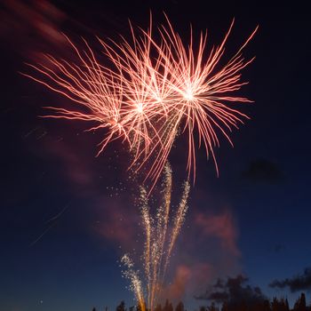 Red colorful fireworks on blue sky background