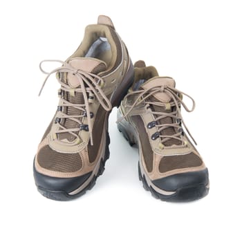 Pair of brown trainers on white isolated background