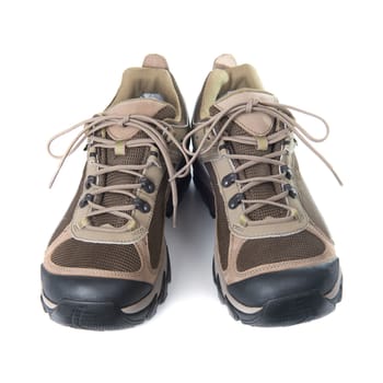 Pair of brown trainers on white isolated background