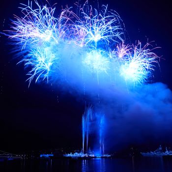 Blue colorful fireworks on the black sky background