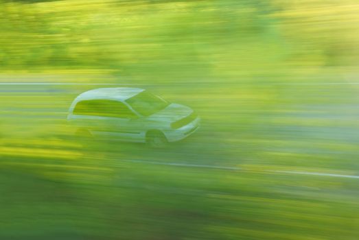 Motion car in the forest. Blurred abstract movement