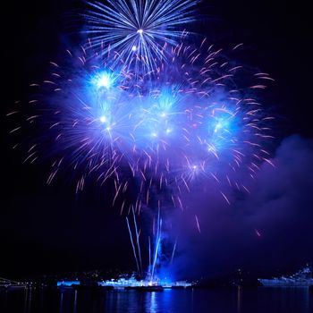 Blue colorful fireworks on the black sky background