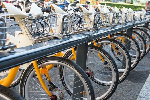 Yellow bikes parking on the street in Europe