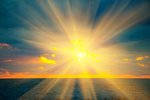 Sunset above sea, with waves, dramatic clouds on the sky