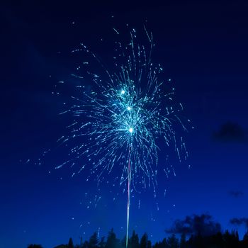 Blue colorful fireworks on night sky background