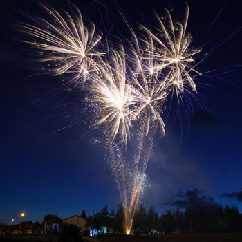 Blue colorful fireworks on night sky background