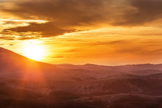 Mountains with and dramatic colorful sky at sunset