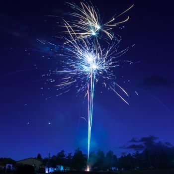 Blue colorful fireworks on night sky background