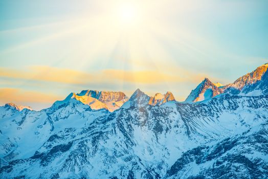 Sunset in mountains covered by snow.