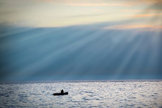 Sea landscape with boat against dramatic sunset