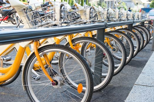 Yellow bikes parking on the street in Europe