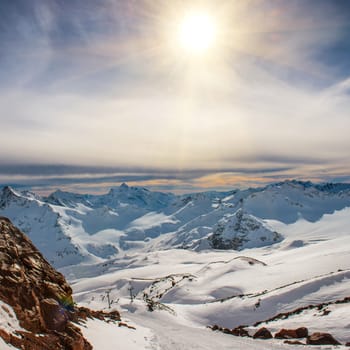 Snowy blue mountains in clouds. Winter ski resort