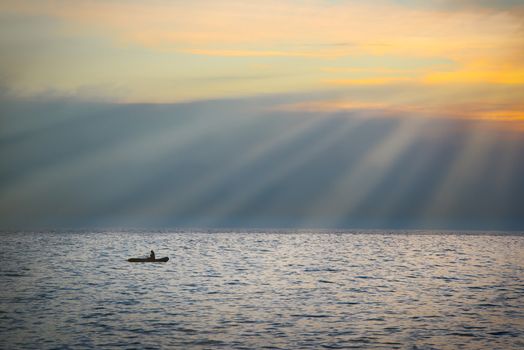 Sea landscape with boat against dramatic sunset