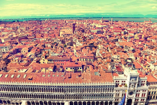 Venice roofs from above. Aerial view of houses, sea and palaces from San Marco tower. Instagram like filter