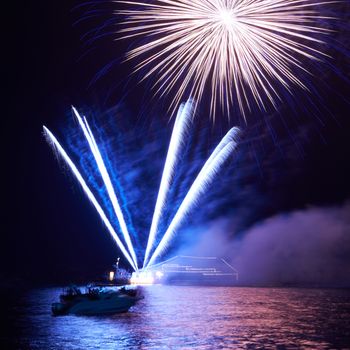 Blue colorful fireworks on the black sky background