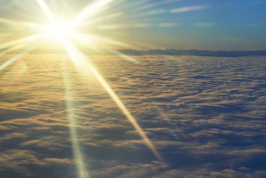 Amazing view from plane on the sky, sunset sun and clouds