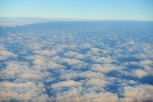 Amazing view from plane on the sky, sunset sun and clouds