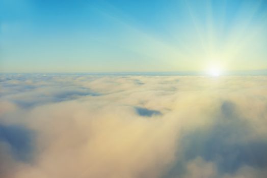 Amazing view from plane on the sky, sunset sun and clouds