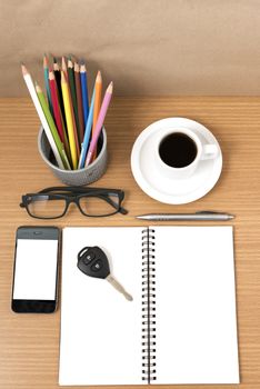 office desk : coffee and phone with key,eyeglasses,notepad,pencil box