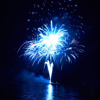 Blue colorful fireworks on the black sky background