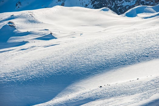 Snowy blue mountains in clouds. Winter ski resort