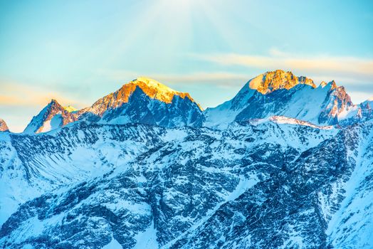 Sunset in mountains covered by snow.