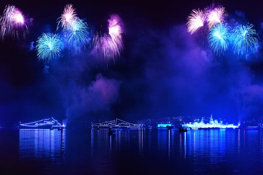 Blue colorful fireworks on the black sky background