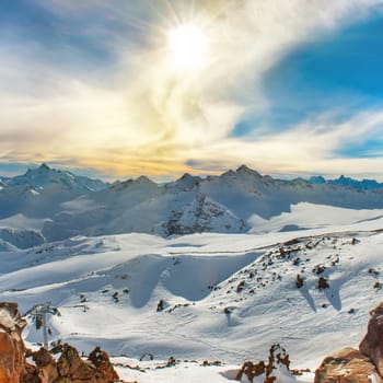 Snowy blue mountains in clouds. Winter ski resort