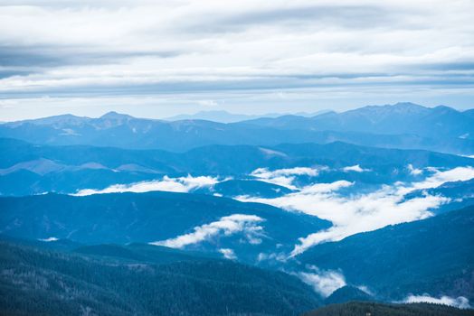 Blue mountains covered with white clouds. Carpathian, Ukraine