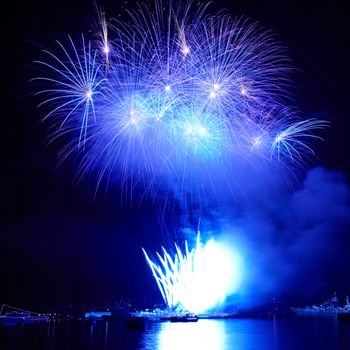 Blue colorful fireworks on the black sky background