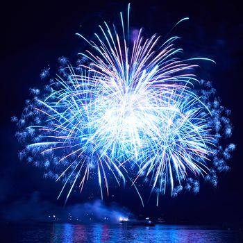 Blue colorful fireworks on the black sky background