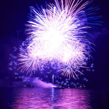 Blue colorful fireworks on the black sky background