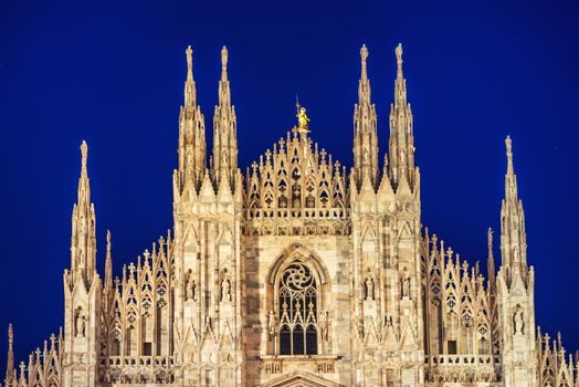 Night view of famous Milan Cathedral (Duomo di Milano) on piazza in Milan, Italy with stars on the blue dark sky