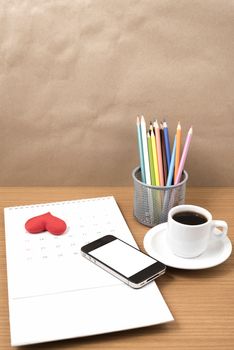 office desk : coffee with phone,calendar,heart on wood background