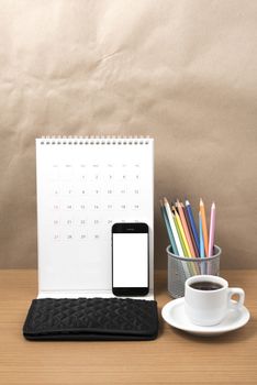 office desk : coffee with phone,calendar,wallet,color pencil on wood background