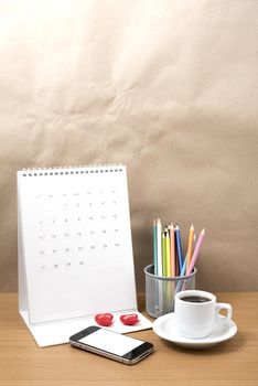 office desk : coffee with phone,calendar,heart,color pencil on wood background