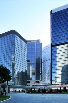 Hong Kong, Hong Kong S.A.R. - December 29, 2014:  People walking between the Central district skyscrapers. The district is in the heart of Hong Kong island and is the main financial district.