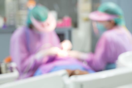Dentist and Dental assistants in hospital ( blurry dental background )