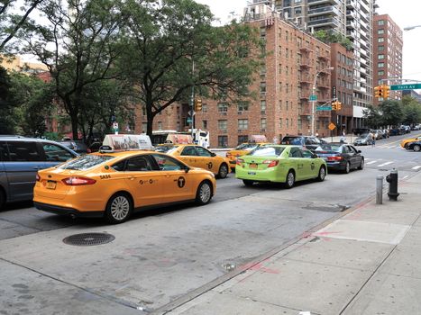 Green and yellow NYC taxi cabs.