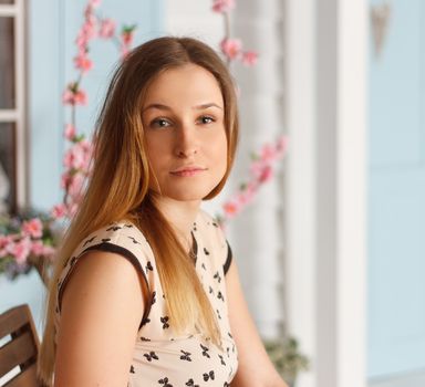 Beautiful girl with long hair in a flowering garden