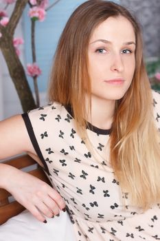 Beautiful girl with long hair in a flowering garden