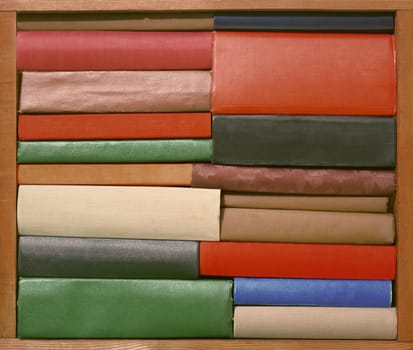 Old books on wooden brown plank shelf