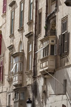 Typical maltese balconies in historical district of capital of Malta - Valletta, Europe.