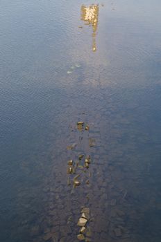 Water surface with sunken remains of walls in the river Ruhr in Hattingen, Germany.