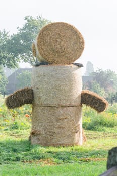 Hay bale figure, in the countryside.