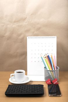 office desk : coffee with phone,wallet,calendar,heart,color pencil box on wood background