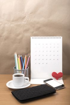 office desk : coffee with phone,wallet,calendar,heart,color pencil box on wood background