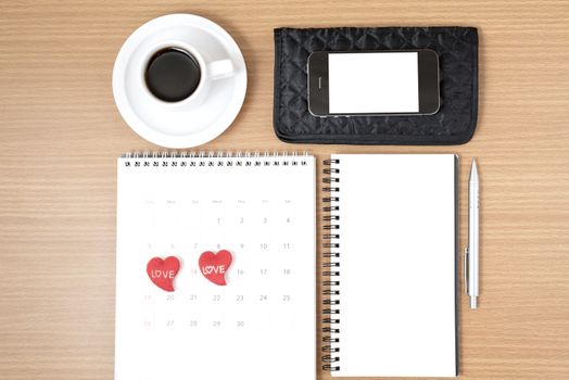 office desk : coffee with phone,wallet,calendar,heart,notepad on wood background